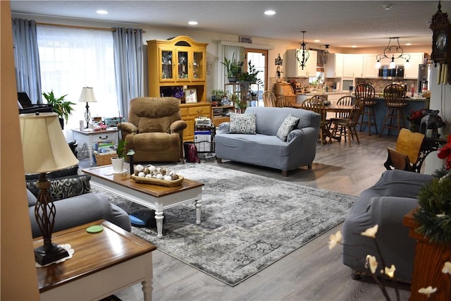 living room with light hardwood / wood-style floors and a textured ceiling