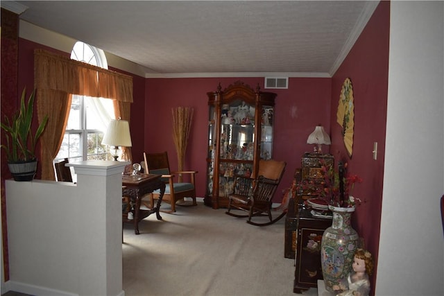 living area with crown molding and light colored carpet