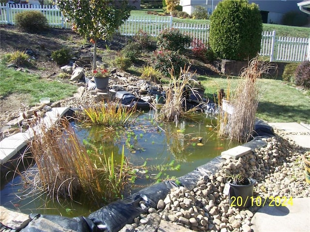 view of home's community with a garden pond