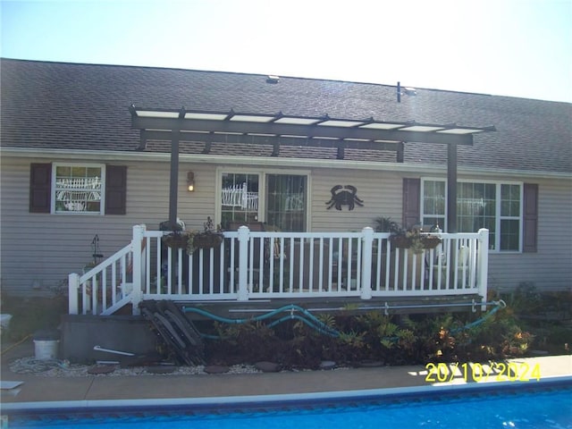 back of house with a pergola