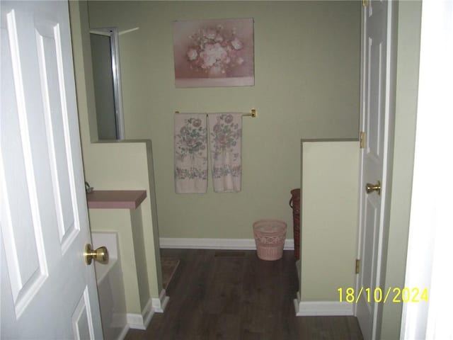 hallway with dark hardwood / wood-style floors