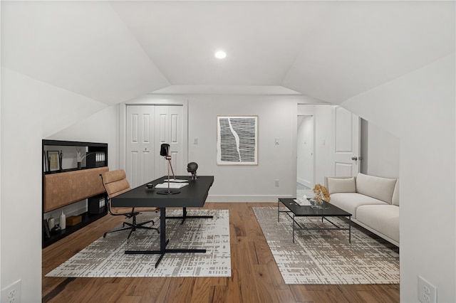 office with lofted ceiling and hardwood / wood-style floors