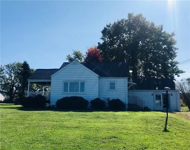 view of property exterior with a yard