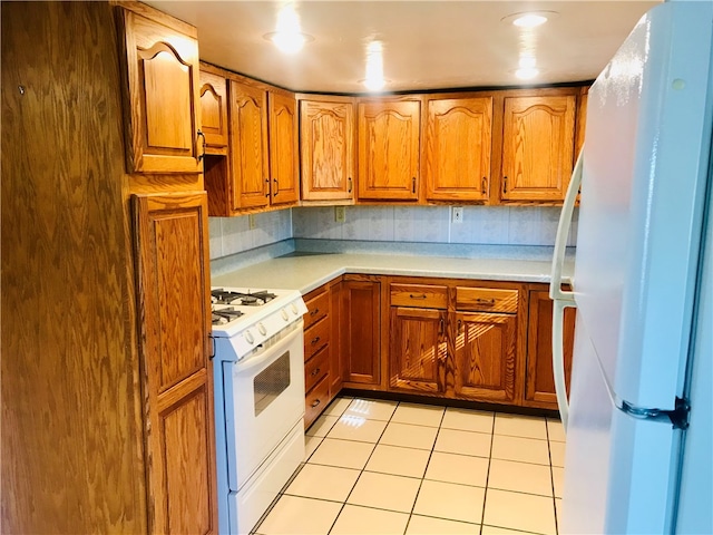 kitchen with white appliances, decorative backsplash, and light tile patterned floors