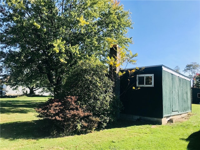 view of outbuilding with a yard