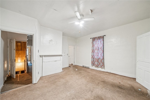 unfurnished living room featuring ceiling fan and light carpet