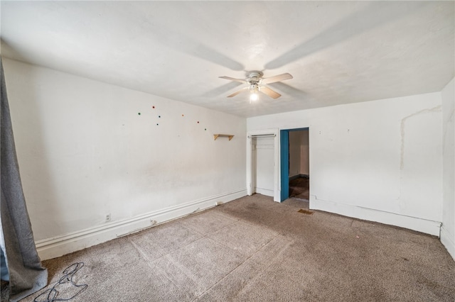 carpeted empty room featuring ceiling fan