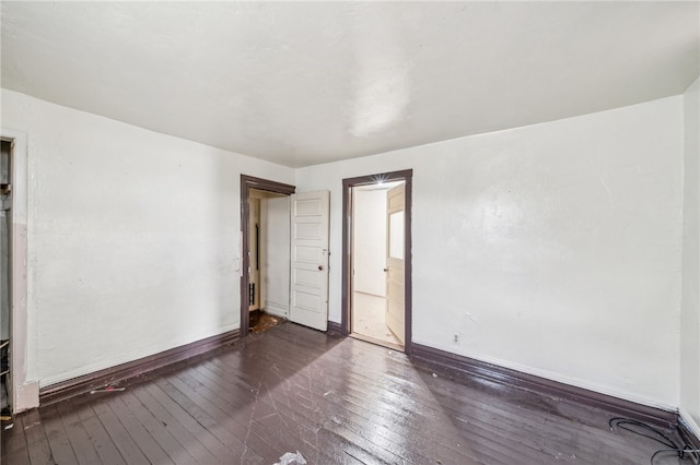 empty room featuring dark wood-type flooring