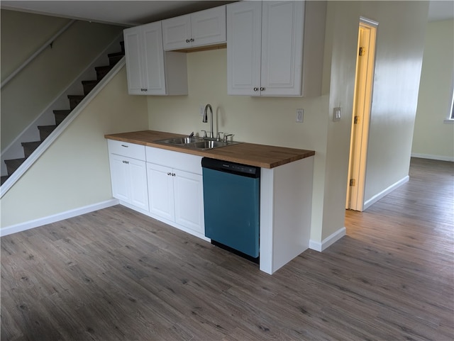 kitchen featuring white cabinets, light wood-type flooring, stainless steel dishwasher, and wooden counters