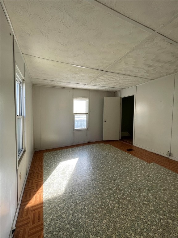 empty room featuring dark parquet flooring