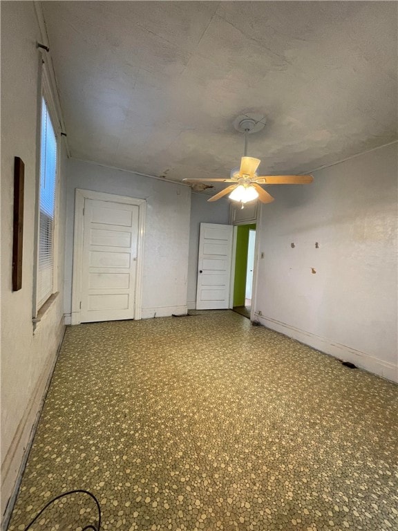 unfurnished room with ceiling fan