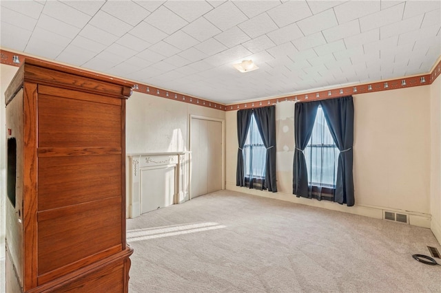 unfurnished living room featuring light carpet