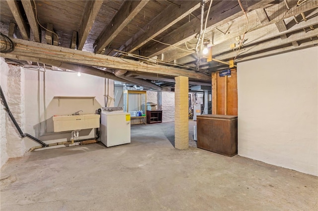 basement with washer / clothes dryer and sink