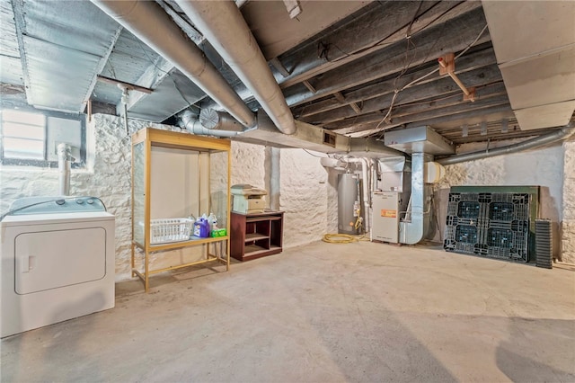 basement featuring water heater, washer / clothes dryer, and heating unit