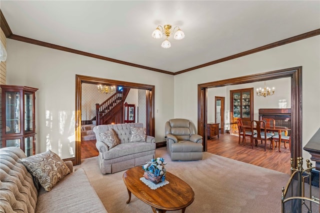 carpeted living room with crown molding and an inviting chandelier