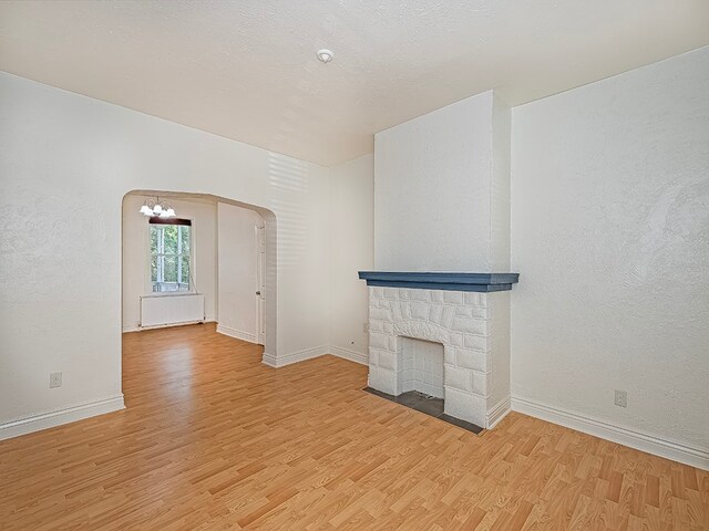 unfurnished living room featuring light hardwood / wood-style floors and a fireplace