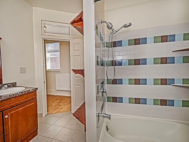 bathroom with vanity, tile patterned floors, shower / tub combination, and radiator