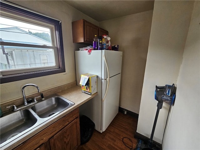 kitchen featuring white fridge, sink, and dark hardwood / wood-style floors