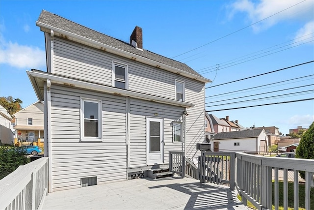 back of house featuring a wooden deck