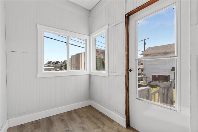 interior space with wooden walls and hardwood / wood-style floors