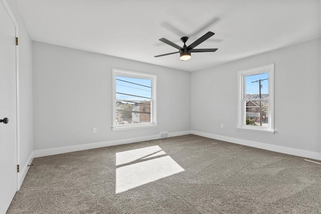 spare room with ceiling fan, carpet floors, and plenty of natural light