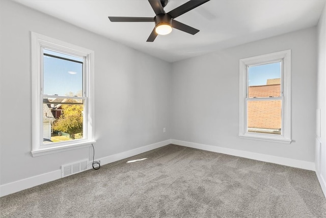 carpeted spare room with ceiling fan