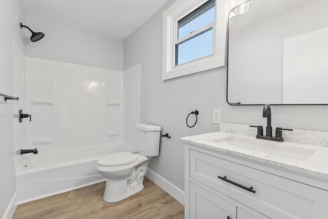 full bathroom featuring bathtub / shower combination, vanity, wood-type flooring, and toilet