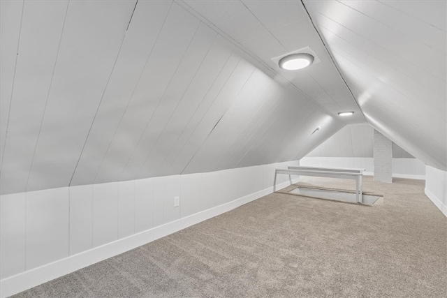 additional living space with carpet and vaulted ceiling