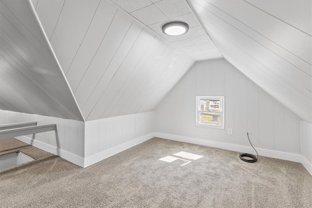 bonus room with lofted ceiling and carpet