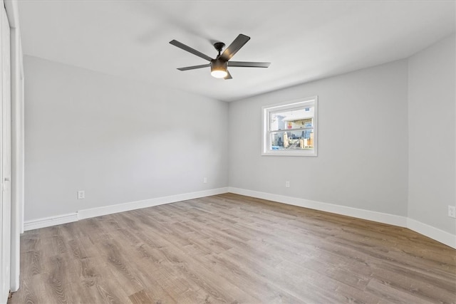 spare room with ceiling fan and light wood-type flooring