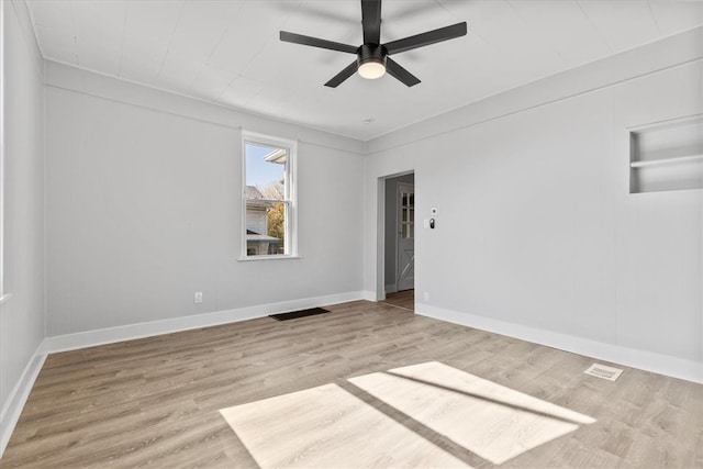 empty room with light wood-type flooring and ceiling fan