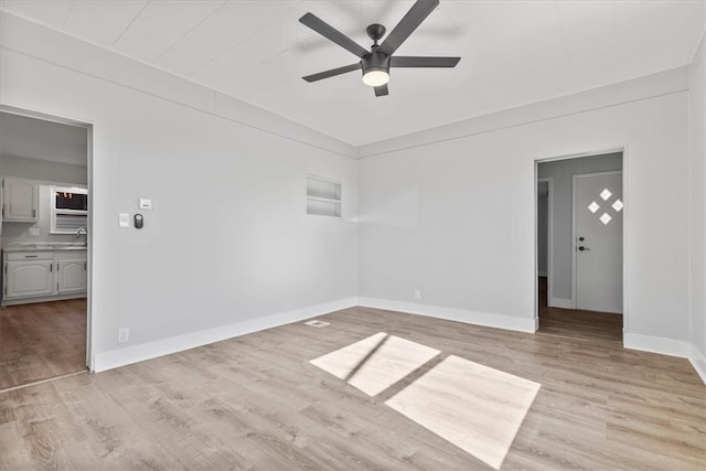 empty room with light hardwood / wood-style flooring and ceiling fan