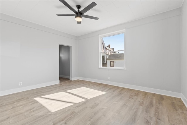 empty room with ceiling fan and light hardwood / wood-style flooring