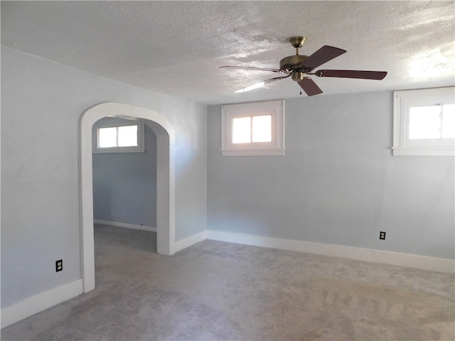 interior space with ceiling fan, a textured ceiling, and plenty of natural light