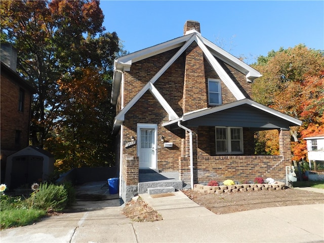 view of front of home featuring a storage shed