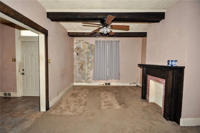 unfurnished living room with carpet, ceiling fan, a textured ceiling, and beam ceiling