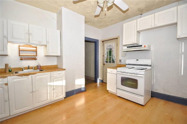 kitchen featuring sink, white cabinets, white stove, light hardwood / wood-style floors, and ceiling fan