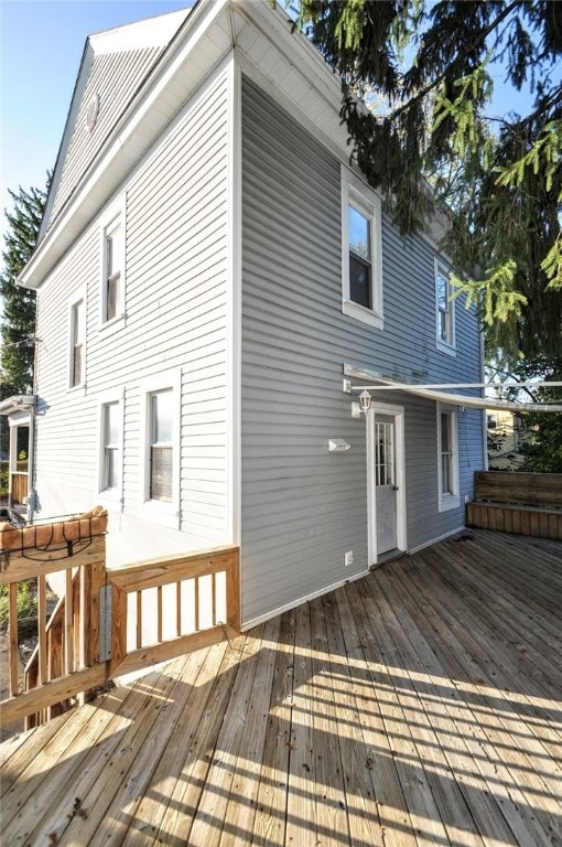 rear view of house featuring a wooden deck