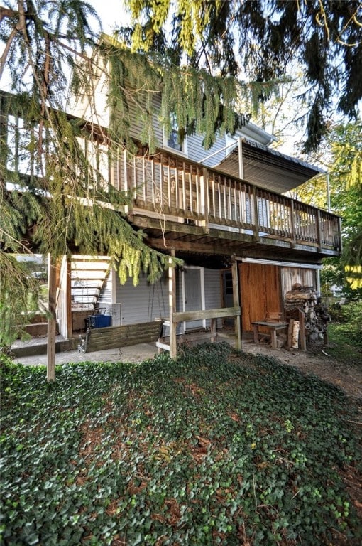 rear view of house with a wooden deck