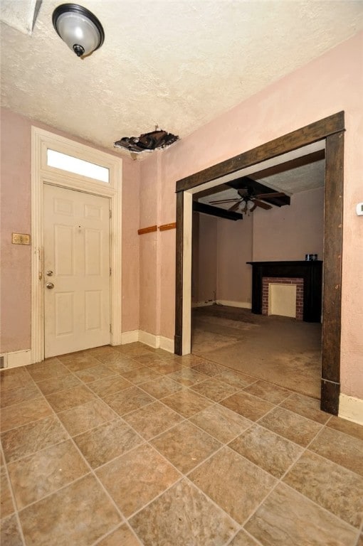 entrance foyer with a textured ceiling and ceiling fan