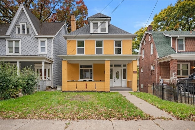 view of front of home featuring a front lawn and covered porch