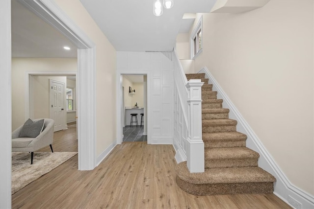 staircase with hardwood / wood-style flooring