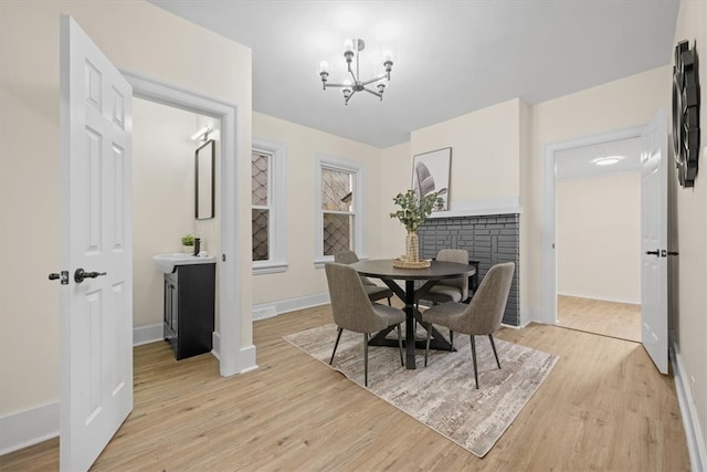 dining room featuring light hardwood / wood-style floors and a chandelier