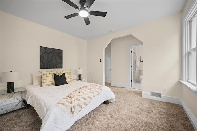 carpeted bedroom featuring ensuite bathroom and ceiling fan