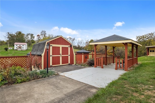 view of patio / terrace with a gazebo and a storage shed