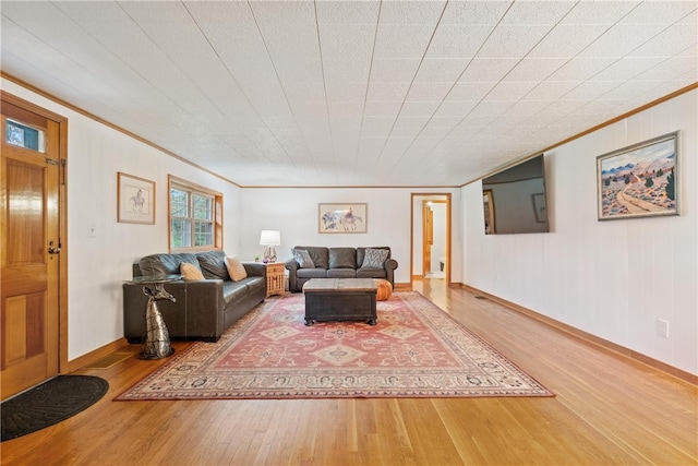 living room featuring ornamental molding and wood-type flooring