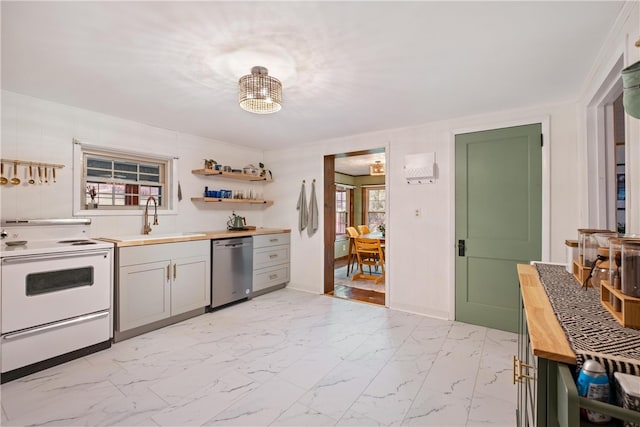 kitchen featuring dishwasher, butcher block counters, sink, white cabinets, and electric stove