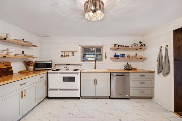 kitchen featuring gray cabinets, sink, appliances with stainless steel finishes, and butcher block counters