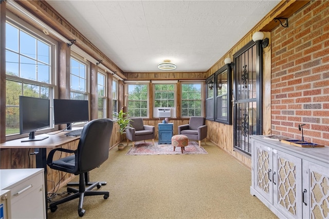 carpeted office space featuring cooling unit, wood walls, and plenty of natural light