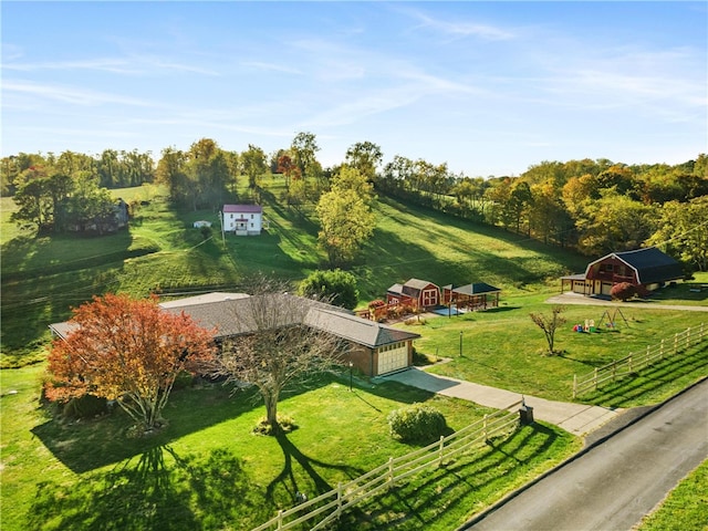 view of home's community with a yard, a shed, and a rural view